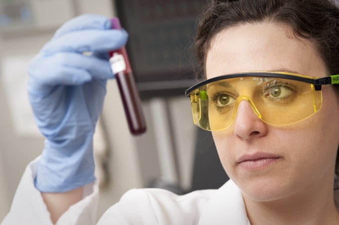 A blood sample tube being examined in a laboratory